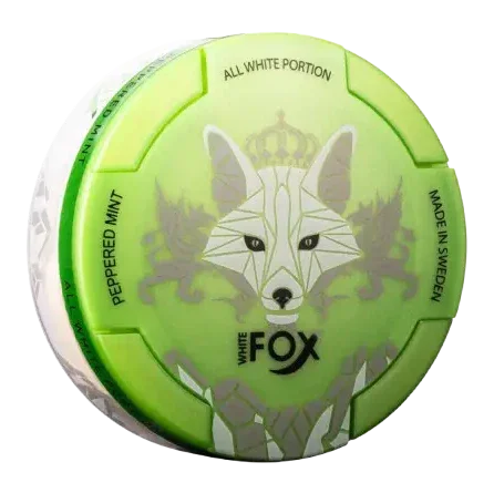 A green and white round container labeled White Fox with a stylised fox design. Text reads Peppered Mint, All White Portion Made in Sweden”.