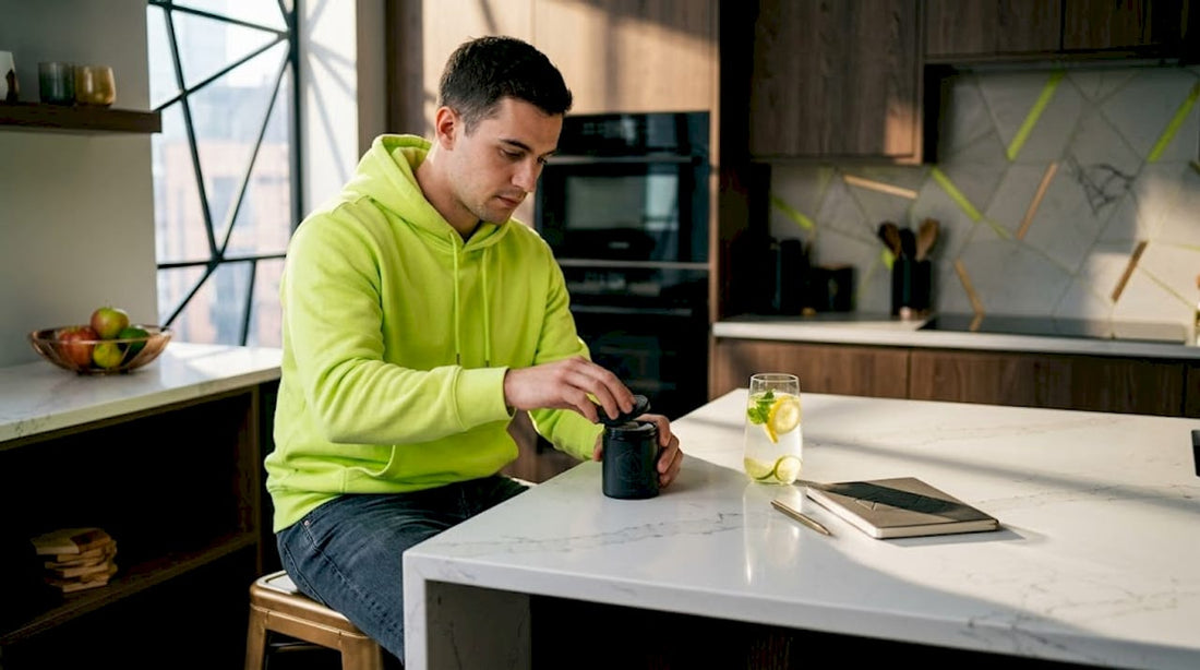 Man closing nicotine pouch tin at table