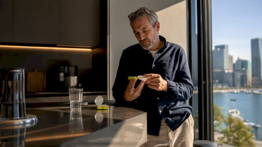 Man inspecting nicotine pouch can at home