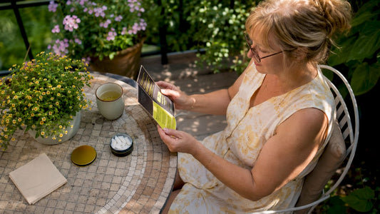 Woman reading nicotine pouch consumer info at table