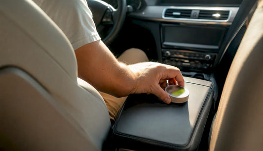 Driver placing nicotine pouch tin inside car