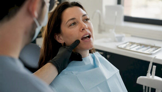 Dentist hand near healing tooth extraction site