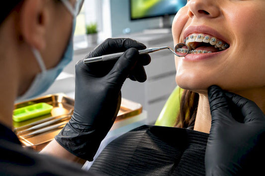 Orthodontist inspecting braces during treatment