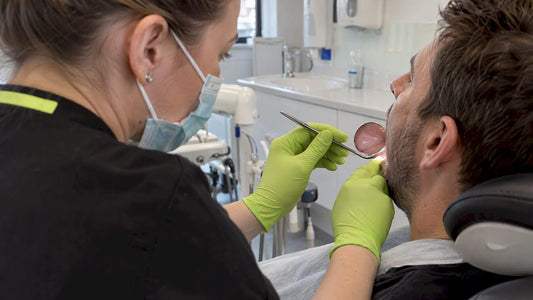 Dental clinician examining a white inner-cheek patch
