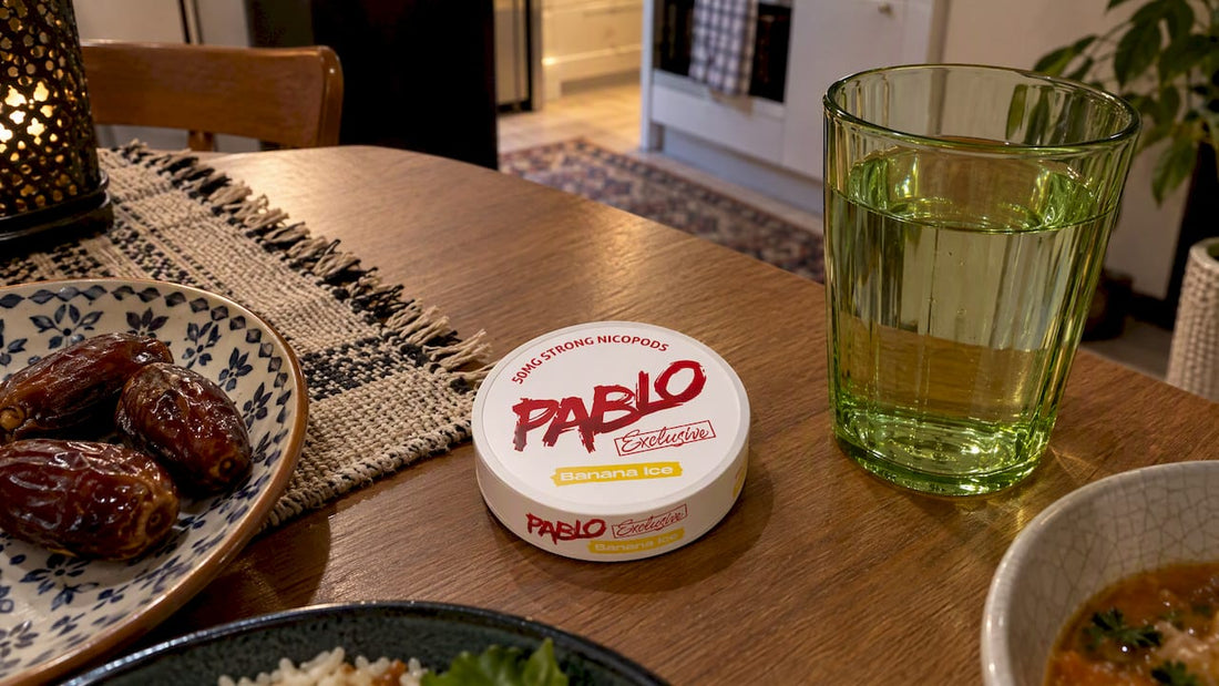 Nicotine pouch tin beside a Ramadan iftar meal